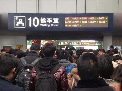 2月5日,在北京西站,等待检票进站的旅客队伍已经排到候车室外,但