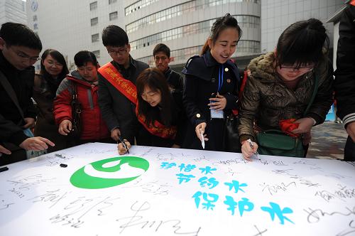 3月22日,市民和大学生志愿者在横幅上签名发出节水护水倡议。当日,为迎接第二十一届“世界水日”和第二十六届“中国水周”,由江苏省水利厅、南京市总工会等发起组织的南京市首届“水美南京”暨“职工节水月”主题活动启动。活动现场举行了市民节水护水互动咨询、大学生节水主题海报展、节水护水主题签名活动。全市职工代表、市民600余人签名响应节水护水倡议。新华社记者 沈鹏 摄