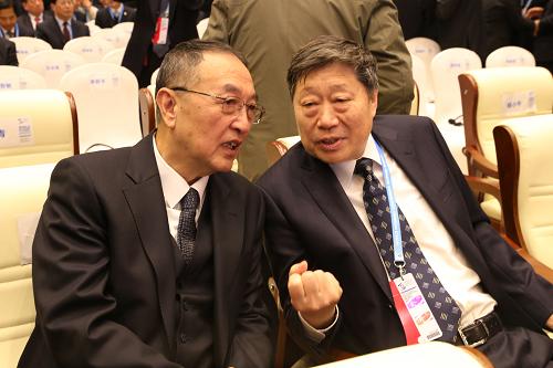 12月16日，联想控股董事长柳传志（左）与海尔集团董事局主席张瑞敏在浙江乌镇举行的第二届世界互联网大会上交谈。新华社发（祝立铭 摄）