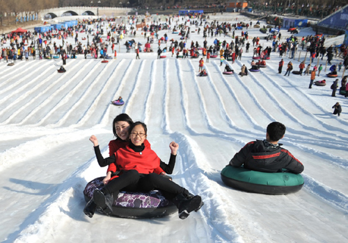 2月9日，游客在北京陶然亭公园的冰雪嘉年华上滑雪圈。当日是农历大年初二，北京市天气晴好，陶然亭公园冰雪嘉年华吸引了不少市民和游客前来休闲娱乐。新华社记者 陈海通 摄