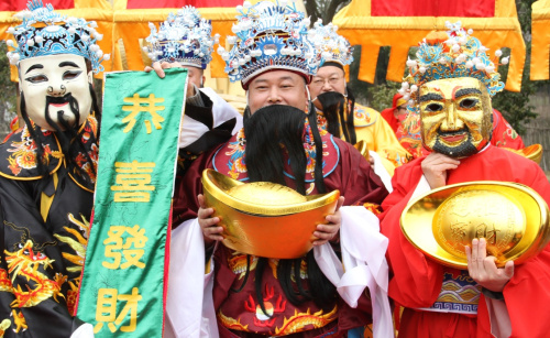 2月12日，“财神”们正在水乡周庄给广大游客们送祝福。新华社发（朱桂根 摄）
