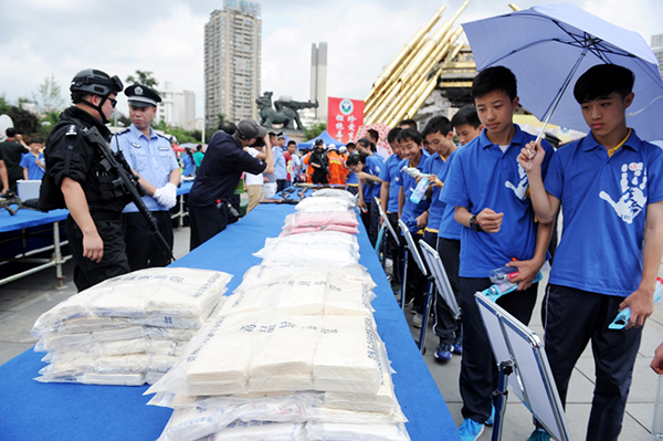 6月26日，青少年学生在贵州贵阳筑城广场观看毒品样品，增强防范意识。