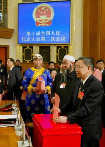 这是2004年3月14日,出席十届全国人大二次会议的代表们投票表决中华人民共和国宪法修正案草案。会议审议通过的宪法修正案将“三个代表”重要思想、尊重和保障人权、保护合法私有财产等内容写入宪法,充分体现以人为本理念。新华社发