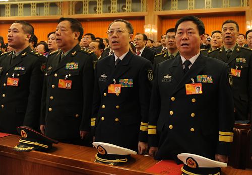 3月14日,第十一届全国人民代表大会第三次会议在北京人民大会堂举行闭幕会。这是全国人大代表在高唱国歌。新华社记者 陈树根摄