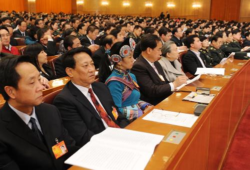 3月9日,十一届全国人大三次会议在北京人民大会堂举行第三次全体会议。这是代表认真听会。 新华社记者 陈树根 摄