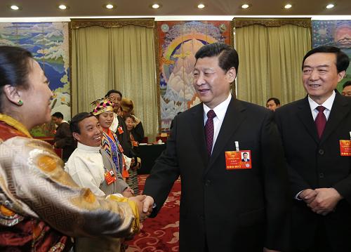 3月9日,中共中央总书记、中共中央军委主席习近平参加十二届全国人大一次会议西藏代表团的审议。这是习近平同代表亲切交谈。新华社记者 鞠鹏 摄