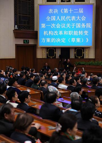 十二届全国人大一次会议举行第四次全体会议 3月14日,十二届全国人大一次会议在北京人民大会堂举行第四次全体会议,选举第十二届全国人民代表大会常务委员会委员长、副委员长、秘书长;选举第十二届全国人民代表大会常务委员会委员;选举中华人民共和国主席、副主席;选举中华人民共和国中央军事委员会主席。这是代表表决关于国务院机构改革和职能转变方案的决定。 新华社记者 李涛 摄