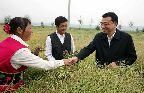 8月23日至25日,中共中央政治局常委、国务院副总理李克强在青海考察。这是8月24日,李克强在海东地区互助土族自治县红咀村油菜地里与村民交谈。 新华社记者 姚大伟 摄