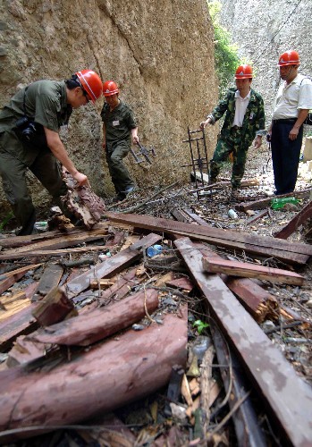 6月20日,河北省古建筑保护研究所的工作人员正在对云岩寺窦真殿被震落下山的古建筑构件进行记录。位于四川省江油市境内的云岩寺是全国重点文物保护单位,云岩寺中的飞天藏殿始建于南宋,是四川省现存最古老的木结构建筑。“5·12”汶川大地震使云岩寺古建筑群遭到极大破坏,玉皇殿、窦真殿、东岳殿、春台等多座建筑整体垮塌,飞天藏殿等墙体坍塌、损坏严重。河北省古代建筑保护研究所日前开始对云岩寺进行现场勘查,对云岩寺古建筑的主要数据与构件进行测量,对残破的部位进行记录,为云岩寺的修复制定保护方案。 新华社记者 巩志宏摄