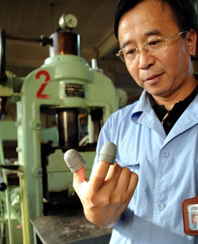 沈阳橡胶研究设计院研究室主任常大勇在展示为“神七”宇航员舱外服研发的“指套”(9月18日摄)。新华社记者 徐扬 摄