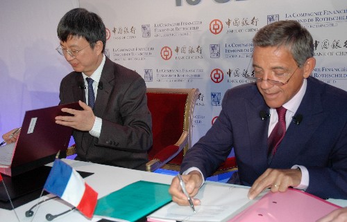 9月18日,中国银行副行长朱民(左)和法国洛希尔银行首席执行官斯居莱勒出席在法国巴黎举行的签字仪式。新华社记者 芦龙军 摄