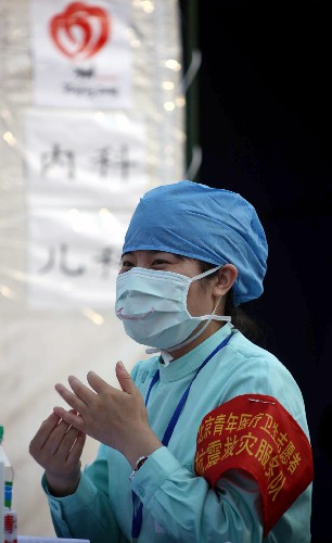 5月22日,一位北京青年医疗卫生志愿者抗震救灾服务队成员在安置中心内。