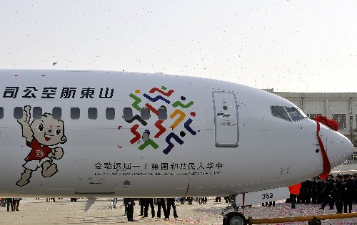 3月13日,绘有十一运会会徽和吉祥物的“全运号”飞机与媒体见面。 当日,由山东航空公司为第十一届全国运动会定制的“全运号”飞机在山东济南亮相。“全运号”飞机机型为波音737-800,是一架168座的中型客机。机身前部绘有第十一届全运会会徽和本届全运会吉祥物“泰山童子”形象,机身后部喷涂“2009山东”字样。“全运号”飞机将主飞北京、上海、广州、南京等曾经举办过全运会的城市航线,除执行正常航班之外,还将按照全运会组委会要求,配合全运会的宣传活动,执行指定航线任务,加大对全运会的推介力度。 新华社记者朱峥摄