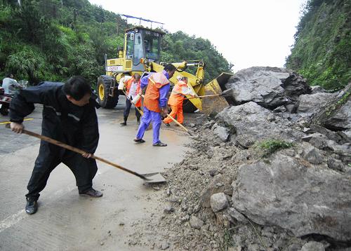 8月10日,在浙江省温岭市泽坎线城南段,温岭市公路段职工清理台风“莫拉克”造成的塌方。新华社发(吴鹏飞 摄)