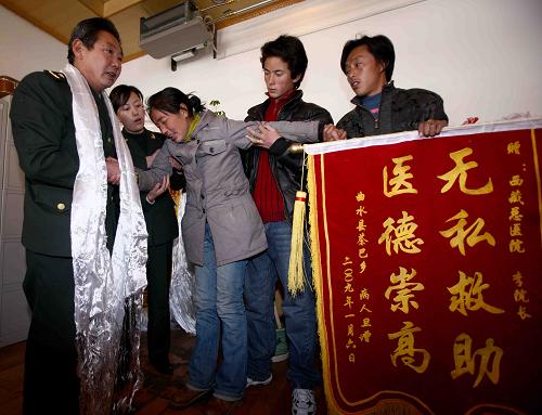 1月8日,一位藏族患者向西藏军区总医院院长李素芝(左一)赠送锦旗,对西藏军区总医院免费治好她的病表示感谢。 新华社记者 陈建力 摄