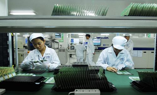 11月10日,江西省九江市共青城工业园区一家手机芯片生产企业的工作人员在进行生产作业。新华社发(胡国林 摄)