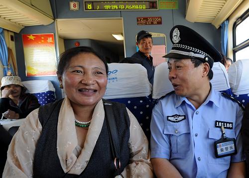 乘警与藏族牧民在火车上拉家常(6月17日摄)。新华社记者 觉果 摄