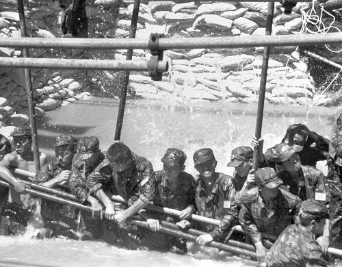 1998年夏,全国上下众志成城,军民干群团结一心,在中华大地谱写了一出威武雄壮的抗洪壮歌。 这是解放军南京军区某部红军团战士在长江大堤决口处用人堤堵住决口(资料照片)。 新华社发