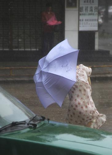 6月11日上午,广东汕头一名居民打着伞顶风冒雨在街头艰难前行。 今年第3号热带风暴“莎莉嘉”于6月11日早晨5时45分在广东汕头市濠江区沿海地区登陆,登陆时中心附近最大风力8级。 广东省气象台预计,“莎莉嘉”登陆后继续向偏北方向移动,强度将迅速减弱。受“莎莉嘉”影响,11日粤东沿海和陆地有5至7级大风,汕头、梅州、揭阳、潮州等地市仍有大到暴雨。 新华社发(姚军 摄)