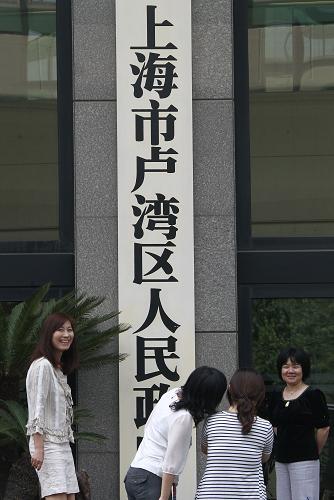 6月8日,几位市民正在上海市卢湾区人民政府门前留影。新华社记者 裴鑫 摄