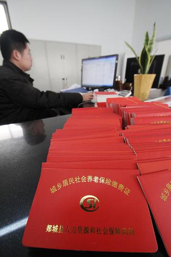12月14日,在山东省临沂市郯城县城乡居民社会养老保险服务大厅,工作人员在打印城乡居民社会养老保险缴费证。新华社发(张春雷 摄)