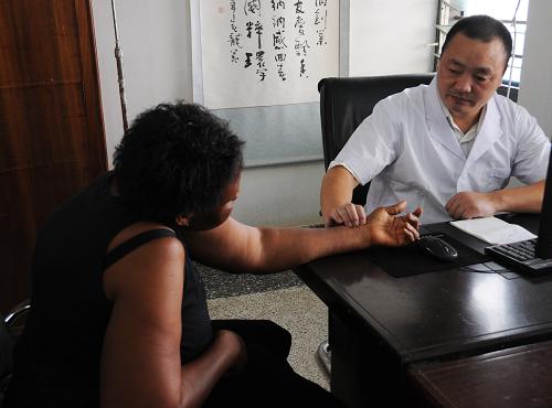 1月9日,加纳新东方医院的医生为一名前来就诊的女士把脉。新华社记者邵海军摄