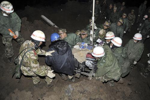 1月12日凌晨,武警官兵将照明设备抬到云南省昭通市镇雄县果珠乡高坡村赵家沟村民小组山体滑坡搜救工作现场。新华社发(郝亚鑫 摄)
