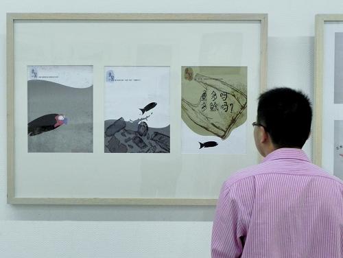 10月19日,参观者在中国美术学院美术馆观看公益广告画《鱼的一天》。新华社发(龙巍 摄)