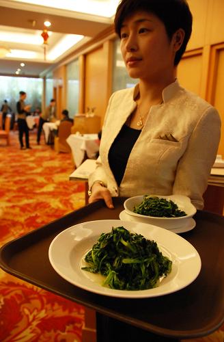 1月29日,在南京市一家四星级酒店,服务员在给消费者上菜,其中一盘是半