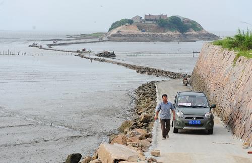 6月26日,一辆小车在600多米长的草屿岛跨海路上行驶。新华社记者 林善传 摄
