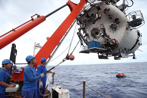 9月7日,红色A形架吊着“蛟龙”号潜水器从甲板摆到海面,操作人员在甲板尾部释放拖曳缆。新华社记者 余晓洁 摄