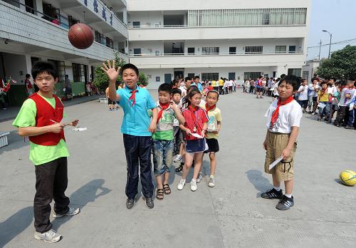 5月31日,孩子们在参加投篮比赛。当日,浙江工业大学药学院的20多名大学生志愿者来到杭州天成教育集团黎明校区,与这里400多名来自外地的孩子们开展了一场名为“大手拉小手,喜迎六一节”的主题活动,共同迎接即将到来的“六一”国际儿童节。在这所专门接受外来务工子女的学校,大学生志愿者们为孩子们开展了丰富多样的游园活动、知识问答、文艺演出等,让孩子们在杭州也能过一个快乐、充实的“六一”国际儿童节。新华社记者 徐昱 摄