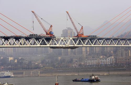 2月5日,轮船从重庆东水门长江大桥下驶过。新华社发(钟桂林 摄)