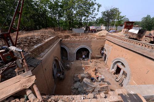 5月18日,在河南省陕县张汴乡曲村,建筑工人在一座地坑院内整修。河南省陕县张汴乡是豫西地坑院较为集中的乡镇,其中曲村就有地坑院115座,具有整修价值的地坑院103座。近年来,随着陕县开发地坑院文化旅游的推进,曲村借助危房改造和土地整理的契机,已陆续对80余座地坑院进行了修复性建设。地坑院又称“地下四合院”,是豫西山区一种“平地挖坑,四壁凿窑”的独特民居形式。目前陕县尚存近万座地坑院。2011年,“地坑院营造技艺”入选第三批国家级非物质文化遗产名录。新华社记者 赵鹏 摄