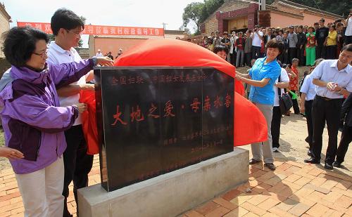 8月22日,中国妇女发展基金会秘书长秦国英(左一)、“母亲水窖”形象大使敬一丹(前右二)在甘肃省通渭县马营镇长川村出席“母亲水窖”揭牌仪式。新华社记者 李明放 摄