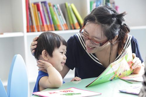 8月9日,在天津图书馆文化中心馆少儿图书阅览室区,一名家长鼓励孩子一起阅读。暑假期间,天津图书馆文化中心馆为市民提供了全天候、全免费服务的文化纳凉场所,同时少儿图书阅览室区新增了近千册优秀读物,不少孩子在家长的带领下来到图书馆享受“文化纳凉”。据介绍,2012年5月启用的天津图书馆文化中心馆区建筑面积5.7万平方米,藏书600万册,实行全天候、全免费24小时自助借还书服务,日均流量超万册。新华社发(李想 摄)