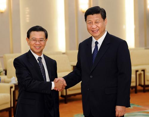 7月23日,国家副主席习近平在北京人民大会堂会见来访的新加坡副总理黄根成。新华社记者 李涛 摄