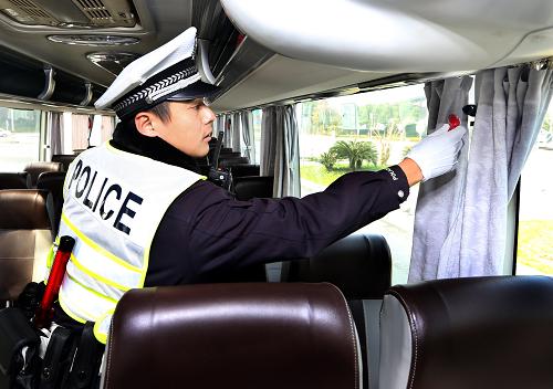12月27日，上海市公安局奉贤分局交警支队民警苏栋在长途客运站检查客车车厢内配备的应急逃生锤。