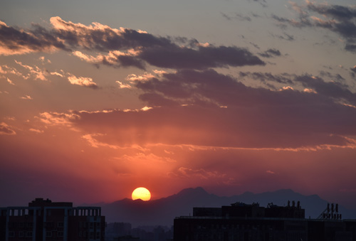 这是2月8日从北京东三环拍摄的夕阳下的远山。