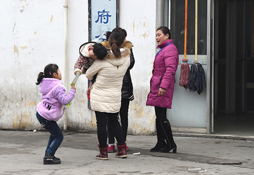 2月13日，在安德门民工就业市场内，中介人员（右一）向两名带孩子的求职者推介岗位。