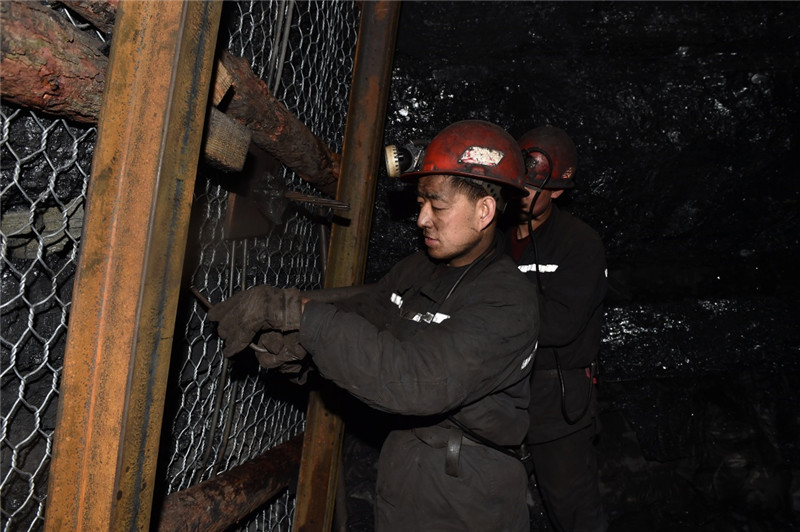 1月27日,在山西焦煤集团官地矿,矿工在井下进行支护作业.