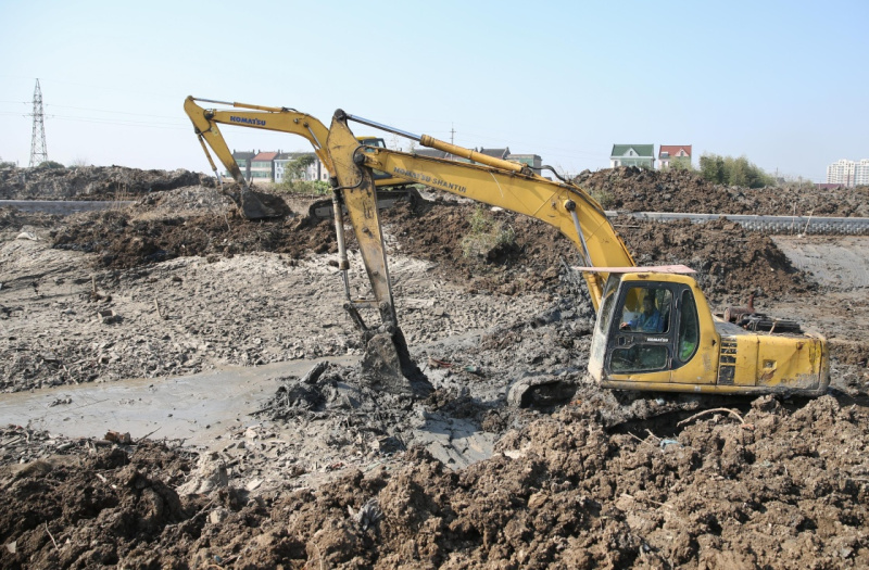 2月15日,工人操作挖掘机在上海市金山区太平港河道内清理淤泥.