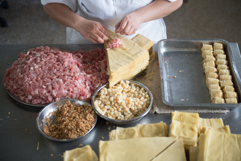 8月6日,工作人员在吴兴区湖东街道丁莲芳配送中心制作千张包子.