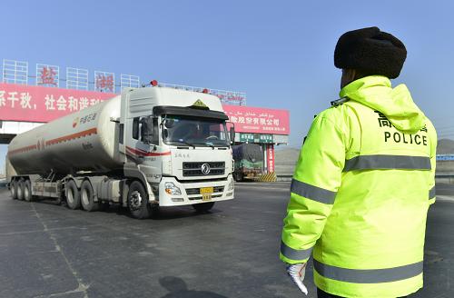 3月13日,在吐乌大公路盐湖收费站,交警在对过往车辆进行巡查。新华社记者 王菲 摄