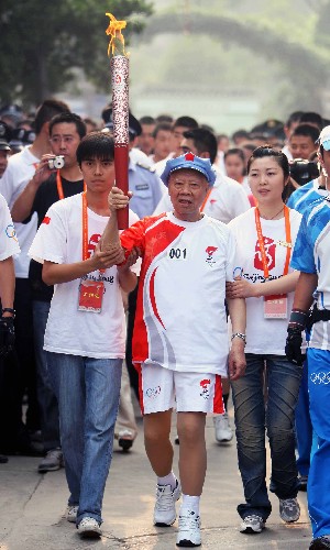 6月14日,第一棒火炬手、93岁高龄的老红军王道金(中)手持火炬传递。当日,北京奥运火炬传递活动在贵州省遵义市举行。 新华社记者邢广利摄