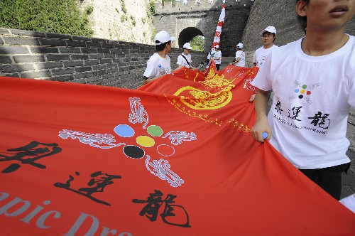 7月13日,志愿者准备将“奥运龙”龙身接在龙头上。 新华社记者 戴旭明 摄