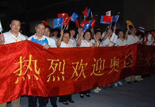 4月18日,中国使馆工作人员在机场热烈欢迎奥运圣火的到来。新华社记者 公磊 摄