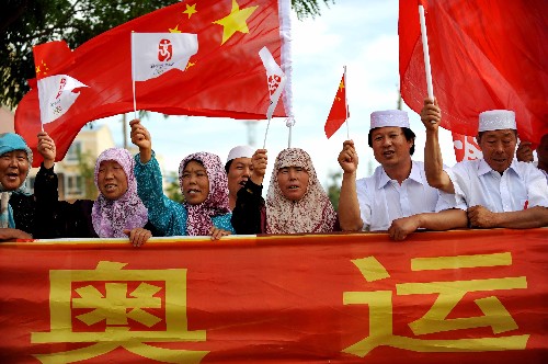 6月30日,当地各族群众为火炬传递加油。当日,北京奥运圣火在宁夏吴忠传递。 新华社记者 王鹏 摄